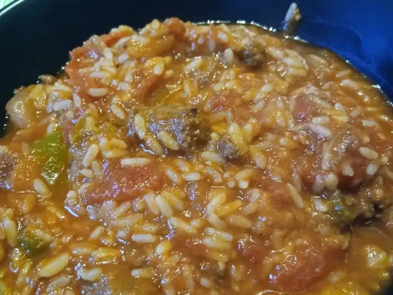 Assiette creuse de riz à la tomate mijoté avec des morceaux de bœuf et des poivrons